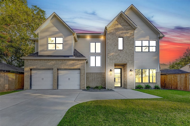 view of front of home with a yard and a garage