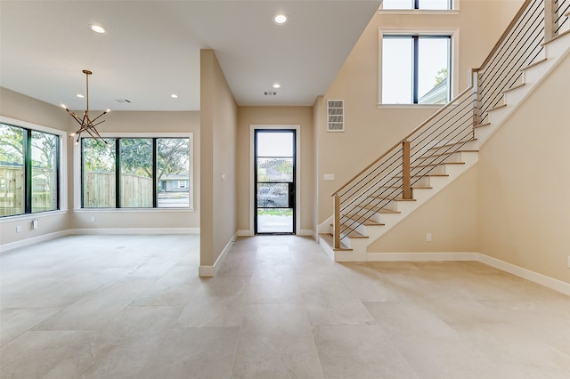 foyer entrance with an inviting chandelier and a healthy amount of sunlight