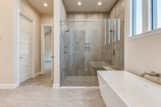 bathroom featuring independent shower and bath and tile patterned flooring