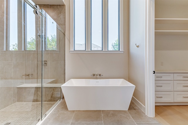 bathroom with plus walk in shower and tile patterned flooring