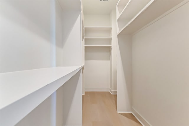 walk in closet featuring light hardwood / wood-style flooring