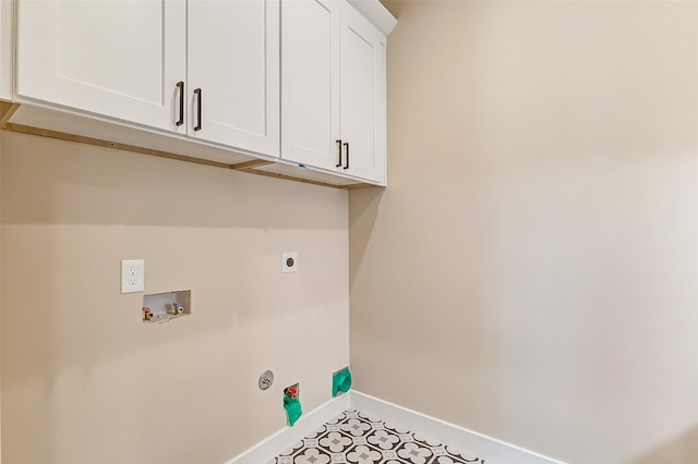 laundry area with electric dryer hookup, washer hookup, and cabinets