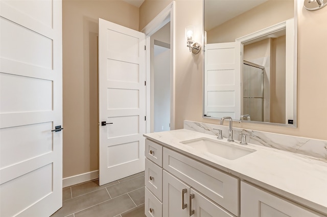 bathroom with vanity, tile patterned floors, and walk in shower