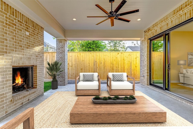 view of patio with an outdoor brick fireplace and ceiling fan