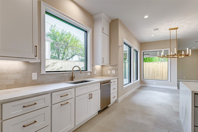 kitchen with hanging light fixtures, white cabinetry, stainless steel dishwasher, a chandelier, and sink