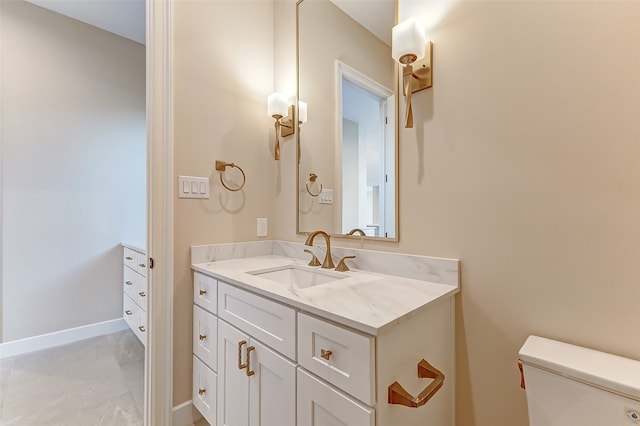 bathroom with vanity, toilet, and concrete floors