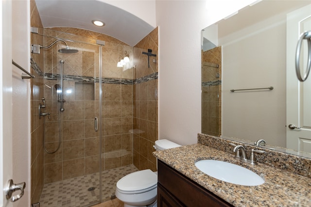 bathroom with toilet, a shower with shower door, and vanity