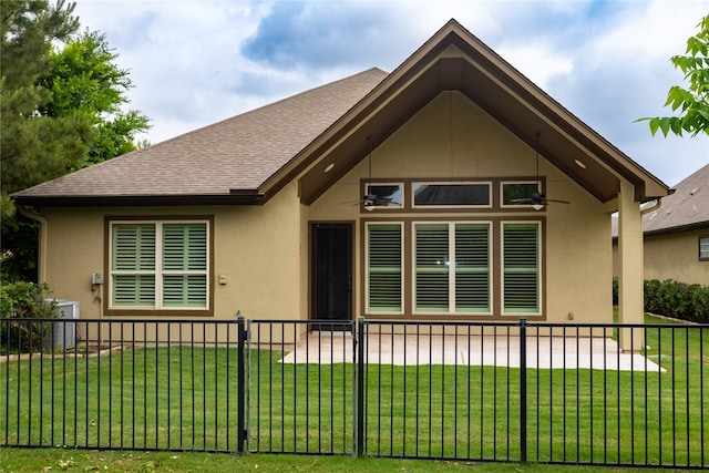 rear view of property featuring a yard