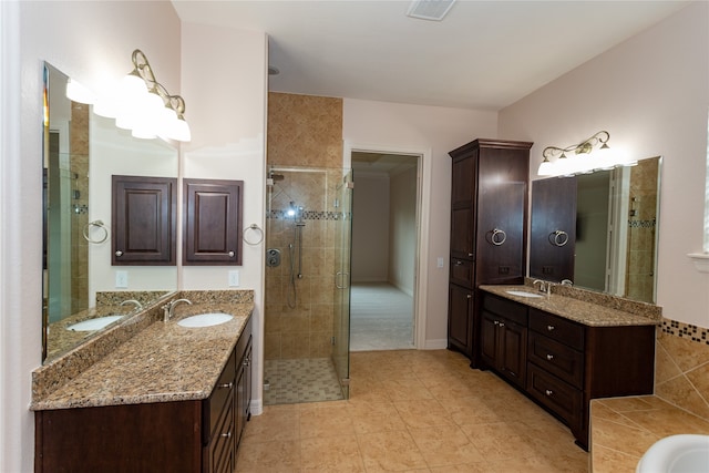 bathroom with vanity, tile patterned flooring, and a shower with door