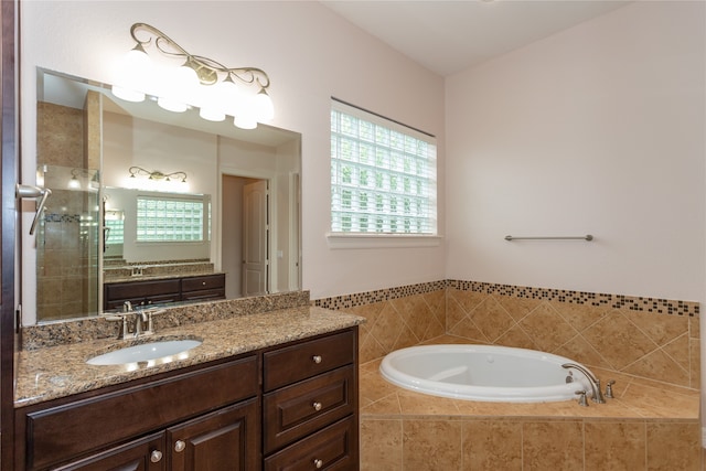 bathroom featuring vanity and separate shower and tub