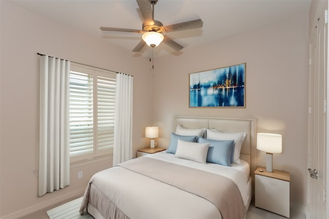 bedroom featuring light carpet and ceiling fan