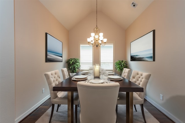 dining space featuring vaulted ceiling, dark hardwood / wood-style floors, and an inviting chandelier