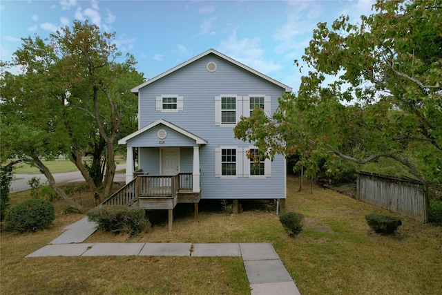 view of front of house featuring a front yard and covered porch