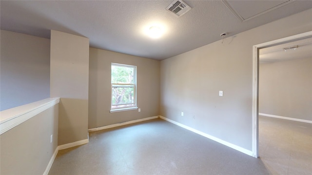 spare room with a textured ceiling