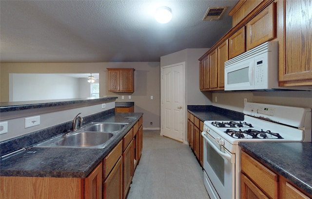 kitchen with sink, a textured ceiling, white appliances, and ceiling fan