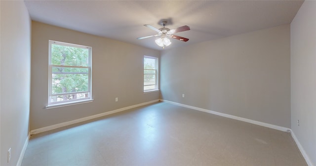 unfurnished room featuring ceiling fan and a healthy amount of sunlight