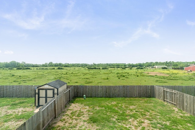 122 Austin Rd, Angleton, TX 77515 - view of yard featuring a fenced backyard, a storage unit, and an outbuilding