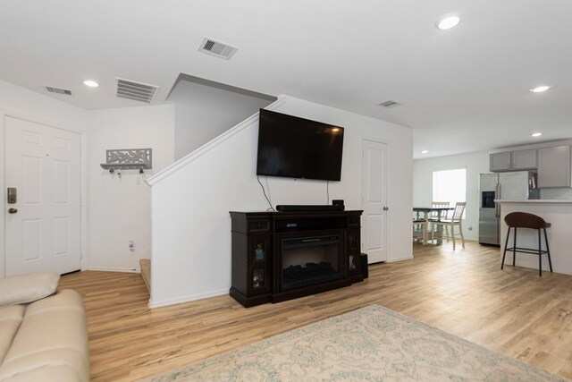 122 Austin Rd, Angleton, TX 77515 - living area with light wood-type flooring, stairs, recessed lighting, and visible vents