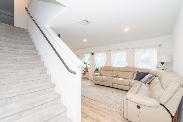 122 Austin Rd, Angleton, TX 77515 - living room featuring light wood-style flooring, stairs, visible vents, and recessed lighting