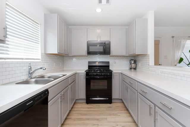 122 Austin Rd, Angleton, TX 77515 - kitchen featuring visible vents, a sink, black appliances, light countertops, and gray cabinets