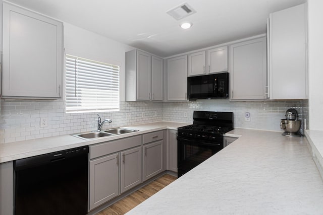 122 Austin Rd, Angleton, TX 77515 - kitchen with gray cabinetry, visible vents, black appliances, and a sink