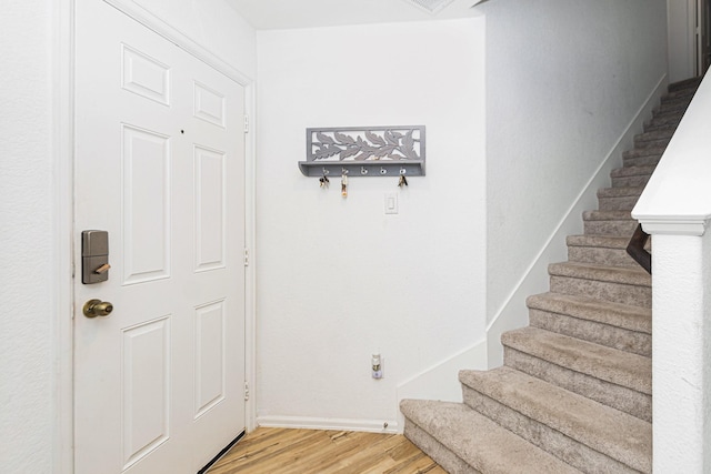 122 Austin Rd, Angleton, TX 77515 - entryway featuring baseboards, stairs, and light wood-style flooring