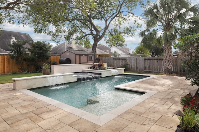 view of pool with a patio and pool water feature