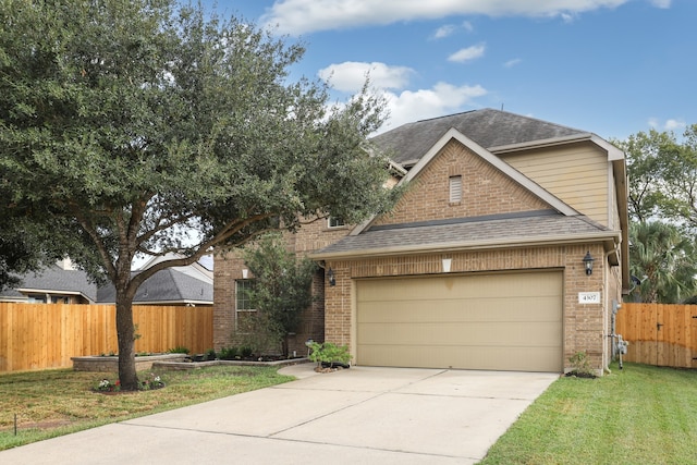 view of front of house with a garage and a front yard