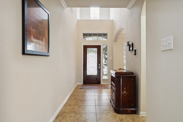 tiled entrance foyer with ornamental molding