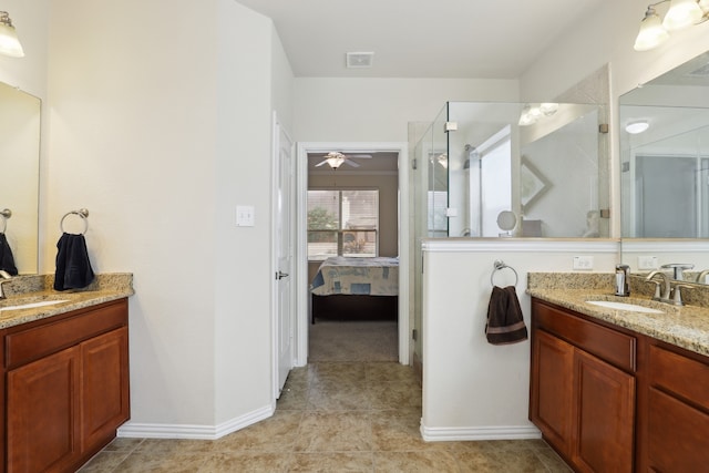 bathroom featuring tile patterned flooring, vanity, ceiling fan, and a shower with door