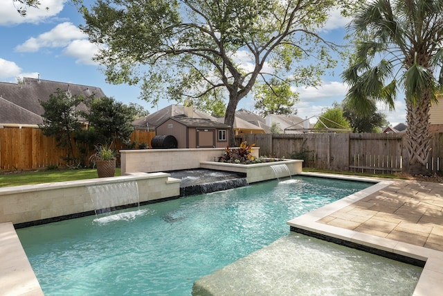 view of pool featuring pool water feature and a patio area