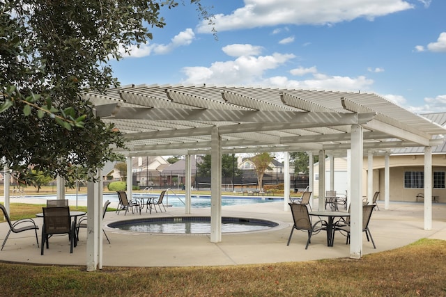 view of patio featuring a community pool and a pergola