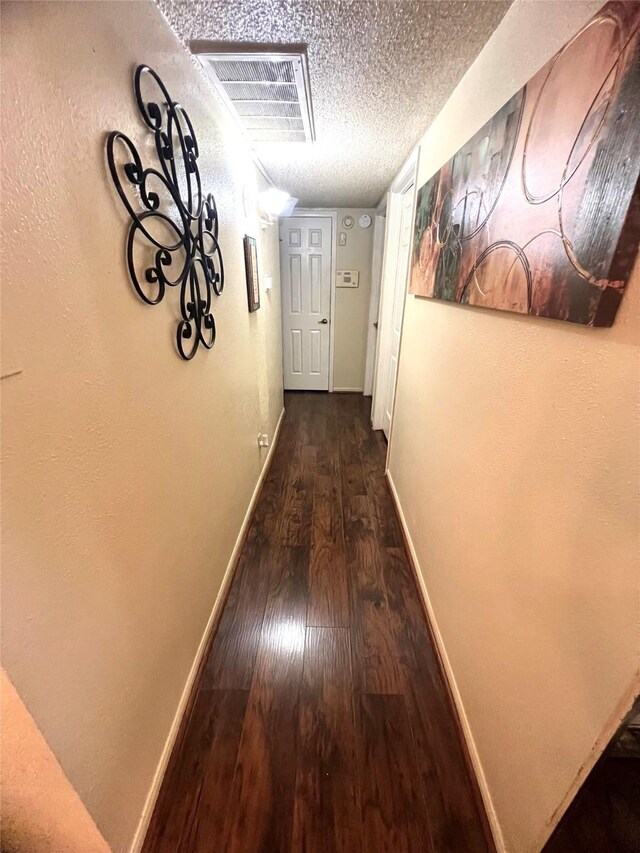 2830 S Bartell Dr Unit 39, Houston, TX 77054 - hallway with baseboards, hardwood / wood-style floors, and a textured ceiling
