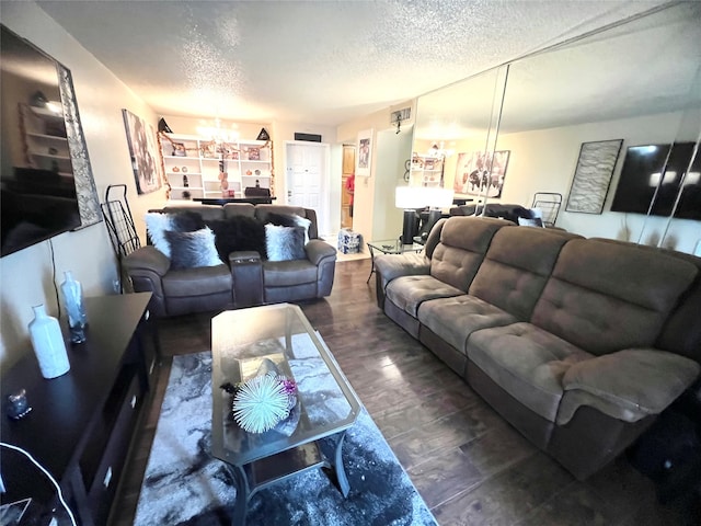 living room featuring a textured ceiling and dark hardwood / wood-style floors