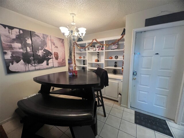 2830 S Bartell Dr Unit 39, Houston, TX 77054 - dining space featuring a chandelier, a textured ceiling, and light tile patterned flooring