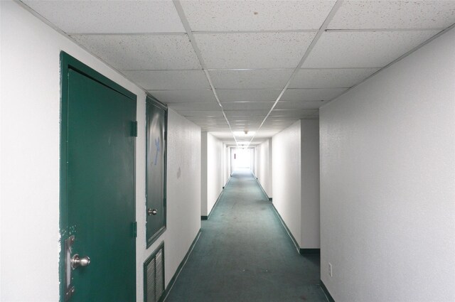 2830 S Bartell Dr Unit 39, Houston, TX 77054 - hallway with a drop ceiling, baseboards, and concrete floors