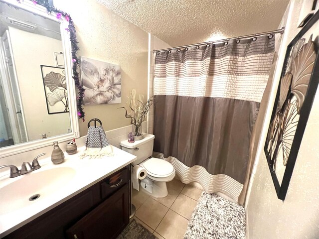 2830 S Bartell Dr Unit 39, Houston, TX 77054 - bathroom featuring a textured ceiling, toilet, vanity, tile patterned flooring, and a textured wall