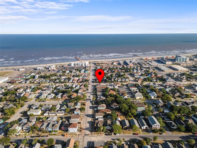 drone / aerial view featuring a view of the beach and a water view