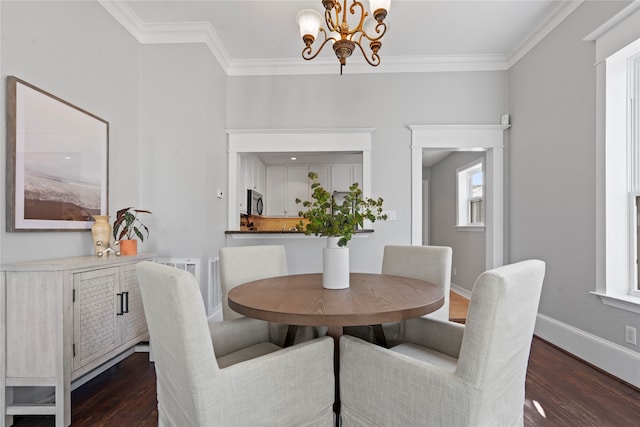 dining area featuring crown molding, a chandelier, and dark wood-type flooring