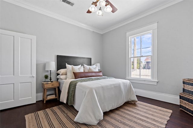 bedroom featuring ceiling fan, crown molding, and dark hardwood / wood-style floors