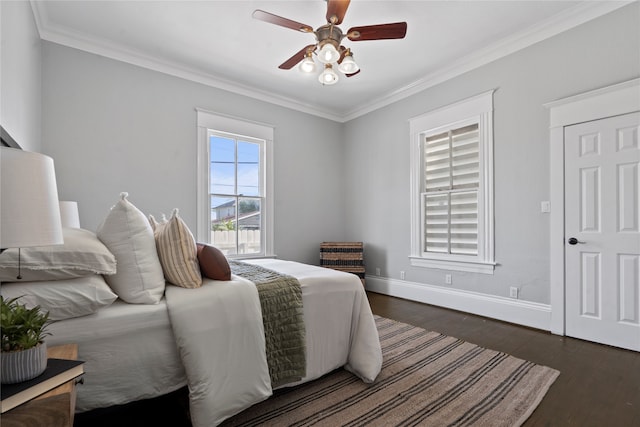 bedroom with ornamental molding, dark wood-type flooring, and ceiling fan