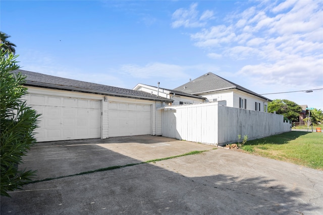 garage featuring a lawn