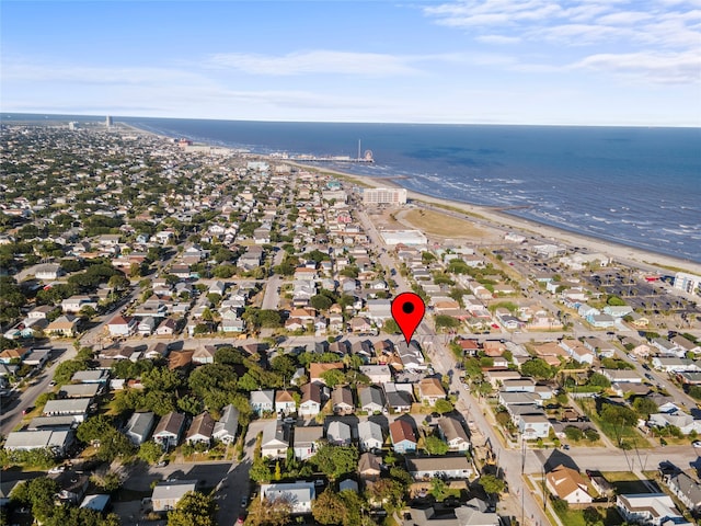 bird's eye view with a water view and a beach view