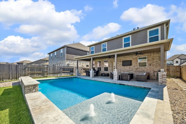 view of swimming pool featuring a patio, an outdoor living space, pool water feature, and ceiling fan