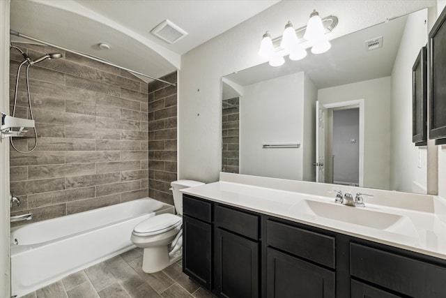 full bathroom with vanity, toilet, and tiled shower / bath