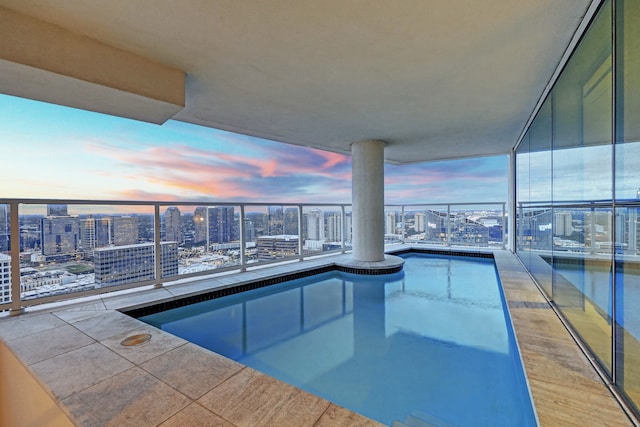 view of pool at dusk