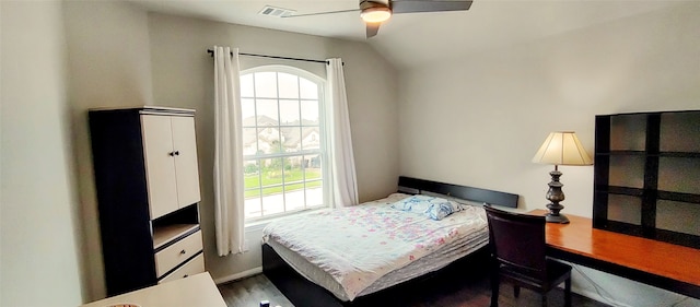 bedroom with ceiling fan, lofted ceiling, and dark hardwood / wood-style flooring