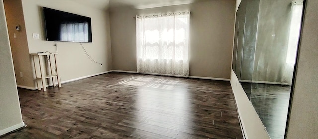 spare room with dark hardwood / wood-style flooring