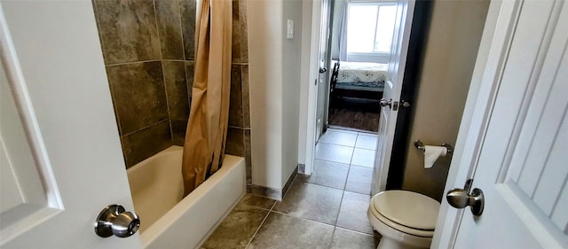 bathroom featuring toilet, shower / bath combination with curtain, and tile patterned flooring