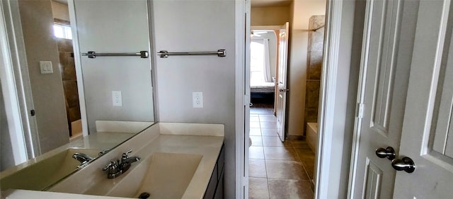 bathroom featuring a washtub, vanity, and tile patterned flooring